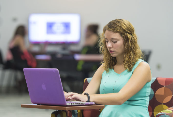 Student Working on Laptop in the Library